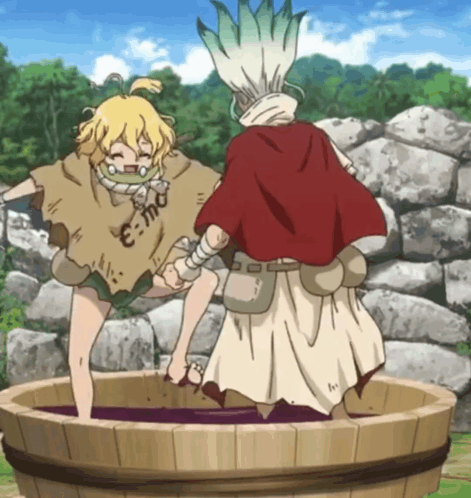 A Man In A Red Cape Stands Next To A Girl In A Barrel With E = Mc2 Written On Her Shirt GIF