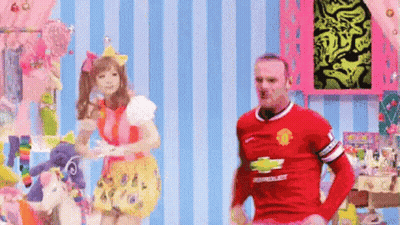 A Man In A Red Chevrolet Jersey Is Standing Next To A Woman In A Pink Dress GIF