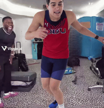 A Man In A Red Dibu Tank Top Is Jumping In The Air GIF