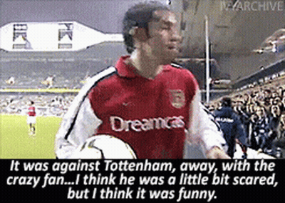 A Man In A Red Dreamcast Jersey Holds A Soccer Ball In Front Of A Crowd GIF