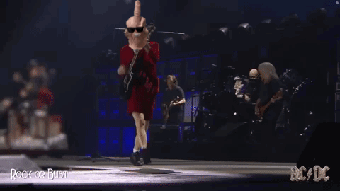 A Man In A Red Dress Is Giving A Middle Finger While Playing A Guitar GIF
