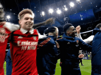 A Man In A Red Emirates Fly Better Jersey Is Being Hugged By Another Man GIF