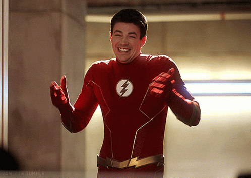 A Man In A Red Flash Costume Is Smiling GIF