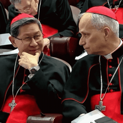 A Man In A Red Hat Has The Word Lje On His Collar GIF