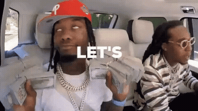 A Man In A Red Hat Is Holding A Stack Of Money While Sitting In A Car . GIF