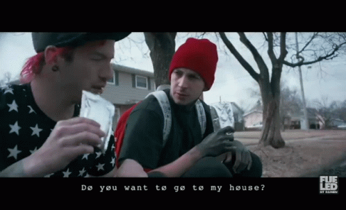 A Man In A Red Hat Is Talking To Another Man In A Black Shirt GIF