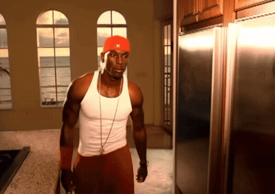 A Man In A Red Hat With The Letter M On It Stands In A Kitchen GIF