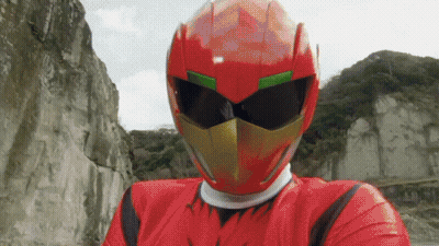A Man In A Red Helmet And Sunglasses Stands In Front Of A Mountain GIF