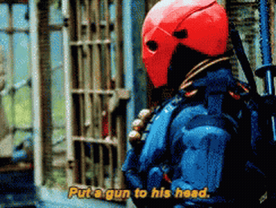 A Man In A Red Helmet Is Holding A Gun And Saying Put A Gun To His Head GIF