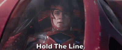 A Man In A Red Helmet Is Sitting In A Car And Says Hold The Line . GIF