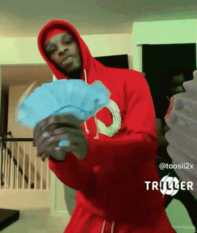 A Man In A Red Hoodie Holds A Fan Of Money GIF