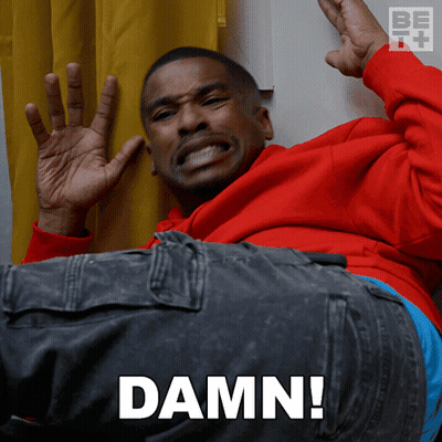 A Man In A Red Hoodie Is Laying Down With The Word Damn Written On The Bottom GIF