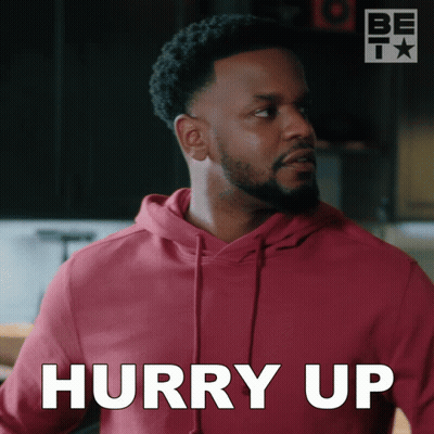 A Man In A Red Hoodie Says Hurry Up In White GIF