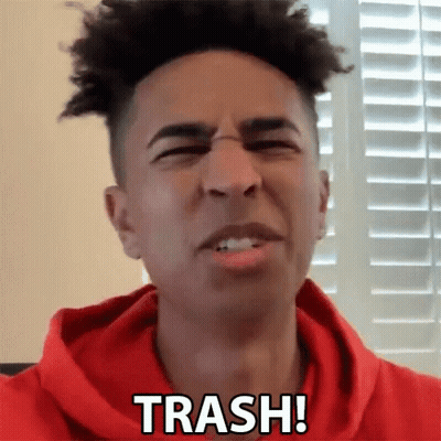A Man In A Red Hoodie Says Trash In Front Of A Window GIF