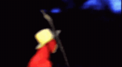 A Man In A Red Jacket And Cowboy Hat Is Holding A Microphone . GIF