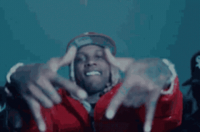 A Man In A Red Jacket And Hat Is Making A Hand Gesture With His Fingers . GIF