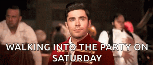 A Man In A Red Jacket And Tie Is Walking Into A Party On Saturday . GIF