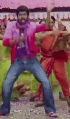 A Man In A Red Jacket Is Dancing In A Crowd GIF