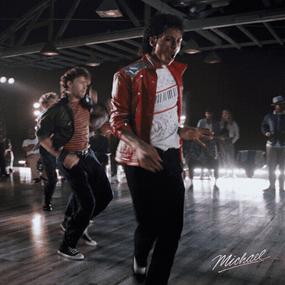 A Man In A Red Jacket Is Dancing In A Room With The Word Michael On The Bottom GIF