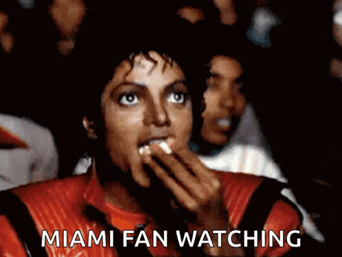 A Man In A Red Jacket Is Eating Popcorn And The Caption Says Miami Fan Watching GIF