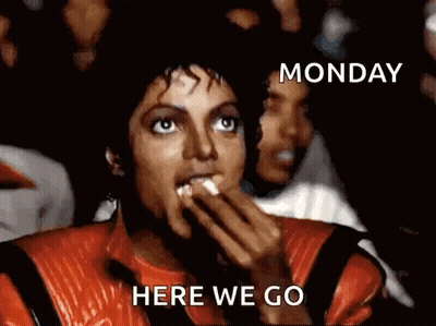 A Man In A Red Jacket Is Eating Popcorn With The Words Monday Here We Go Below Him GIF