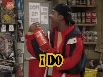A Man In A Red Jacket Is Holding A Can Of Soda With The Word Ido On It GIF