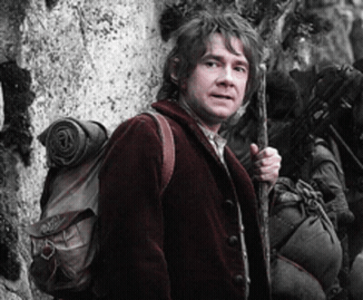 A Man In A Red Jacket Is Holding A Cane And A Backpack GIF