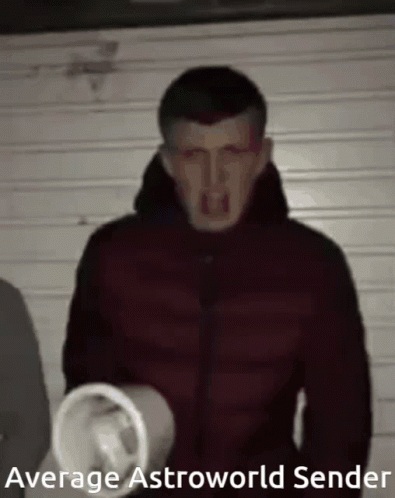 A Man In A Red Jacket Is Holding A Megaphone In His Hand . GIF