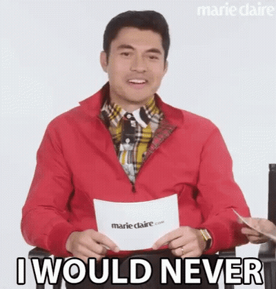 A Man In A Red Jacket Is Holding A Piece Of Paper And Saying `` I Would Never '' While Sitting Down . GIF