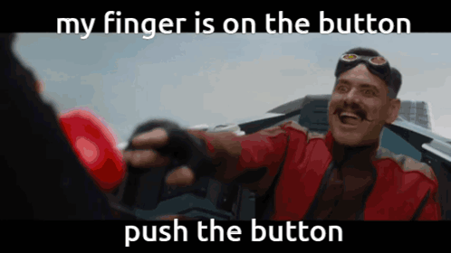 A Man In A Red Jacket Is Holding A Red Boxing Glove And Says " My Finger Is On The Button Push The Button " GIF