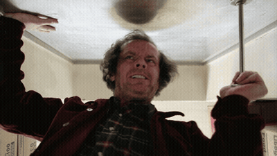 A Man In A Red Jacket Is Holding A Screwdriver In His Hand GIF
