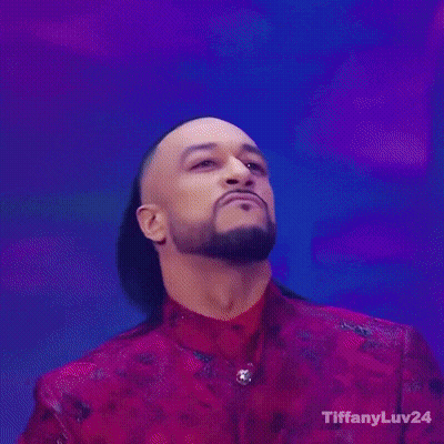 A Man In A Red Jacket Is Holding A Trophy With Tiffanyluv24 On The Bottom Right GIF