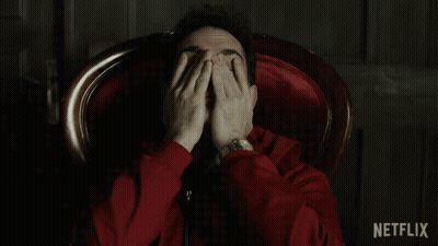 A Man In A Red Jacket Is Sitting In A Chair With Netflix Written In The Corner GIF