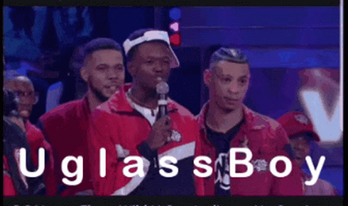 A Man In A Red Jacket Is Speaking Into A Microphone With The Words " Uglassboy " On The Bottom GIF