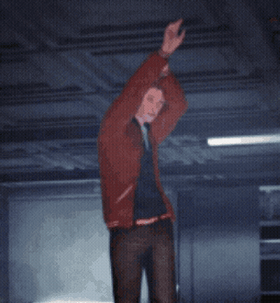 A Man In A Red Jacket Is Standing In A Dark Room With His Hands In The Air GIF