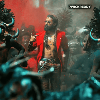 A Man In A Red Jacket Is Standing In Front Of A Crowd And The Words 7Wickreddy Are On The Bottom Right GIF