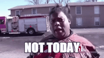 A Man In A Red Jacket Is Standing In Front Of A Fire Truck With The Words `` Not Today '' Written On It . GIF