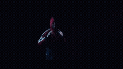 A Man In A Red Jacket Is Standing In Front Of A Group Of Dancers Holding Drums GIF