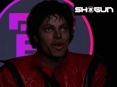 A Man In A Red Jacket Is Standing In Front Of A Logo That Says Shogun GIF