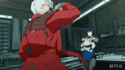 A Man In A Red Jacket Is Standing Next To A Woman In A Blue Uniform With A Netflix Logo On The Bottom Right GIF