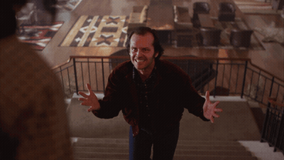 A Man In A Red Jacket Is Standing On A Set Of Stairs With His Arms Outstretched GIF