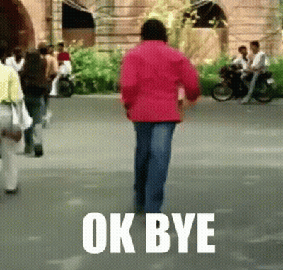 A Man In A Red Jacket Is Walking Down A Street With The Words Ok Bye Written On The Ground . GIF