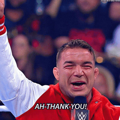 A Man In A Red Jacket Says Ah-Thank-You In Front Of A Microphone GIF