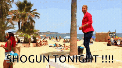 A Man In A Red Jacket Stands On A Beach With The Words Shogun Tonight !!! GIF