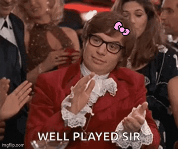 A Man In A Red Jacket With A Hello Kitty Bow On His Head Applauds . GIF