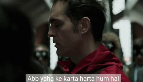 A Man In A Red Jacket With The Words Abb Yaha Ke Karta Harta Hum Hai On The Bottom GIF
