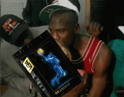 A Man In A Red Jersey Is Holding A Bag That Says Season On It GIF