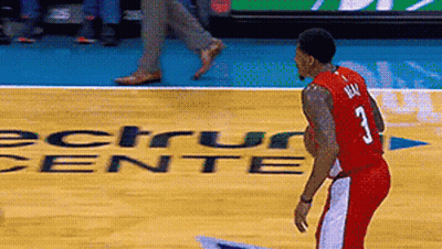 A Man In A Red Jersey With The Number 3 On It Stands On A Basketball Court GIF