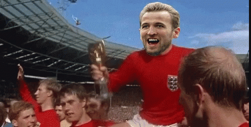 A Man In A Red Jersey With The Word England On It Is Holding A Trophy GIF