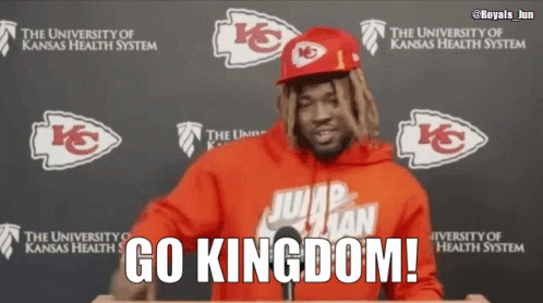 A Man In A Red Jumpman Hoodie Stands In Front Of A Podium With The Words Go Kingdom Written On It GIF